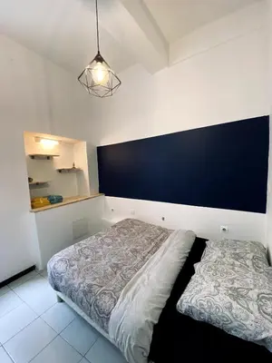 a bedroom with a bed and a black wall at Loft au coeur du centre historique in Narbonne
