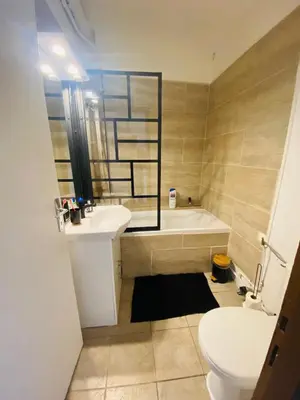 a bathroom with a tub and a sink and a toilet at Logement coeur de ville in Narbonne