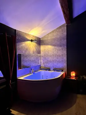 a large bathroom with a tub and a mirror at Love room Narbonnaise in Narbonne