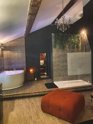 a large bathroom with a tub and a large tub at Love room Narbonnaise in Narbonne