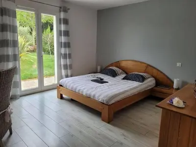 a bedroom with a bed and a large window at Villa Jade in Lasserre-de-Prouille