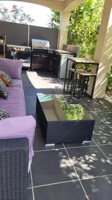 a patio with a couch and a table at Villa Jade in Lasserre-de-Prouille