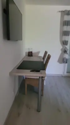 a table in a room with a chair and a mirror at Villa Jade in Lasserre-de-Prouille