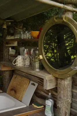 a mirror sitting on top of a wooden shelf at Jolie cabane avec vue magique sur la montagne in Bugarach