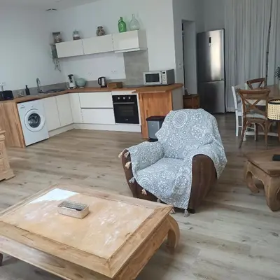 a living room with a couch and a table at Le gîte des lavandiéres in Quarante