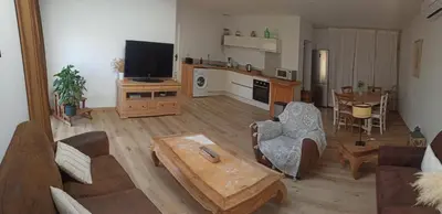 a living room with a couch and a table at Le gîte des lavandiéres in Quarante