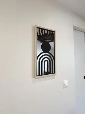 a mirror hanging on a wall on a wall at Japandi en centre-ville in Narbonne
