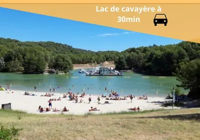 a group of people on a beach with a boat in the water at Le refuge du canal Local à vélo Face canal du midi in Castelnaudary