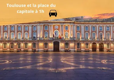 a large building with a car parked in front of it at Le refuge du canal Local à vélo Face canal du midi in Castelnaudary