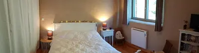 a bedroom with a white bed and a window at Villa en bois tout confort in Bize-Minervois