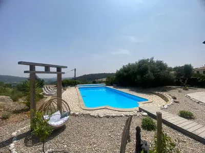 a swimming pool in a yard with a gazebo at Villa en bois tout confort in Bize-Minervois