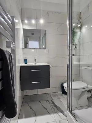 a white bathroom with a sink and a toilet at Studio cabine climatisé magnifique vue port in Gruissan