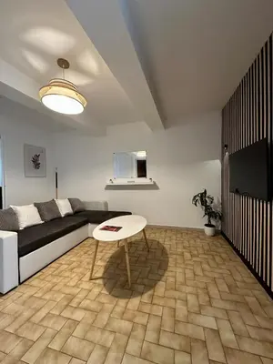 a living room with a couch and a table at Charmant Appartement - 2 chambres - Carcassonne Centre in Carcassonne