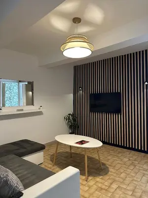 a living room with a couch and a table at Charmant Appartement - 2 chambres - Carcassonne Centre in Carcassonne