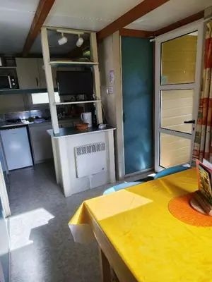 a kitchen with a stove top oven in a room at Hébergement au Lac des Montagnès pour 5 personnes in Mazamet