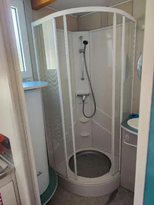 a shower in a small bathroom with a sink at Hébergement au Lac des Montagnès pour 5 personnes in Mazamet
