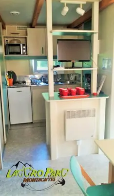 a kitchen with a counter and a kitchen with a counter top at Hébergement au Lac des Montagnès pour 5 personnes in Mazamet