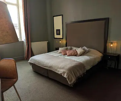 a bedroom with a bed with two pillows on it at Le Château de La Pomarède in La Pomarède