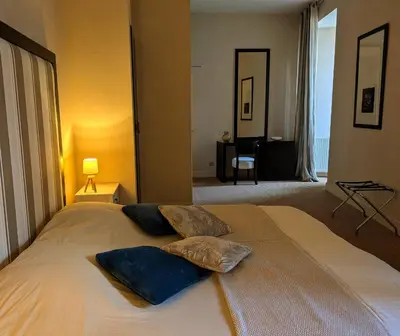 a bedroom with a bed with two pillows on it at Le Château de La Pomarède in La Pomarède