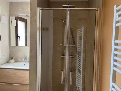 a shower with a glass door in a bathroom at Escapade au Somail in Le Somail