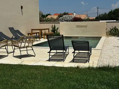 a group of chairs sitting next to a swimming pool at Escapade au Somail in Le Somail