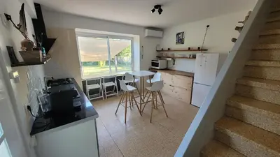 a kitchen with a staircase and a kitchen with a table at Le Clos des Oiseaux in Narbonne