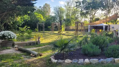 a garden with a fence and a gazebo at Le Clos des Oiseaux in Narbonne