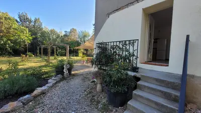 a house with some plants in a yard at Le Clos des Oiseaux in Narbonne