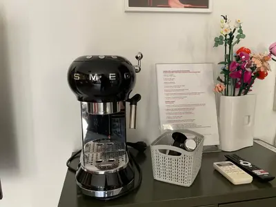 a black coffee maker sitting on a counter next to a phone at Entrez en lice, Face à la Cité vue sublime in Carcassonne