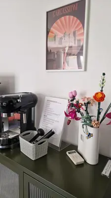 a desk with a coffee maker and flowers on it at Entrez en lice, Face à la Cité vue sublime in Carcassonne