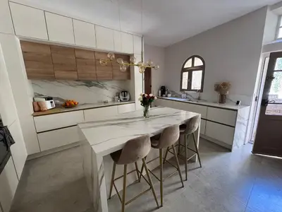 a kitchen with a table with two chairs and a counter at La paisible, coeur de ville Narbonne in Narbonne