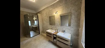 a bathroom with two sinks and a mirror at La paisible, coeur de ville Narbonne in Narbonne