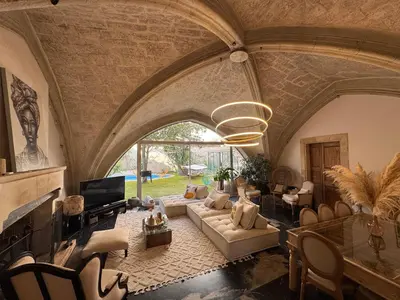 a large living room with a couch and a tv at La paisible, coeur de ville Narbonne in Narbonne