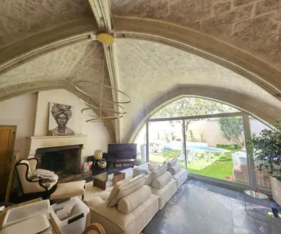 an archway in a living room with a couch and a fireplace at La paisible, coeur de ville Narbonne in Narbonne