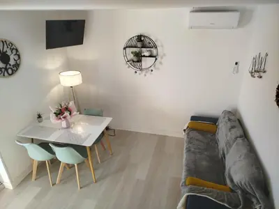 a living room with a table and a couch at Côté Marina in Gruissan