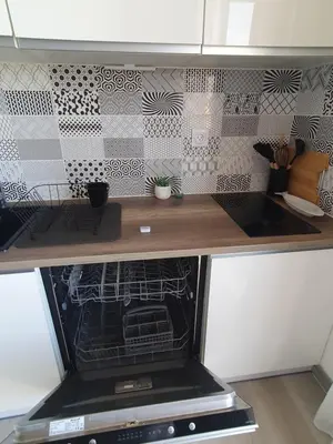 a kitchen with an oven with a wooden counter top at Côté Marina in Gruissan