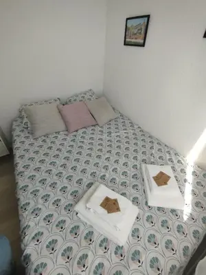 a bed with two towels on top of it at Côté Marina in Gruissan