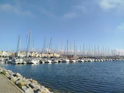 a bunch of boats are docked in a harbor at Côté Marina in Gruissan