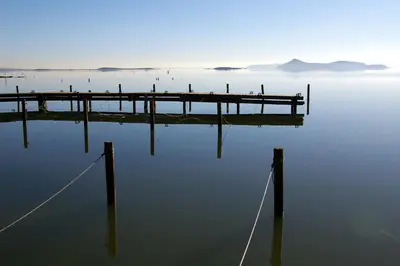 a dock in the middle of a body of water at gite de l'ille, avec terrasse et parking privé in Peyriac-de-Mer