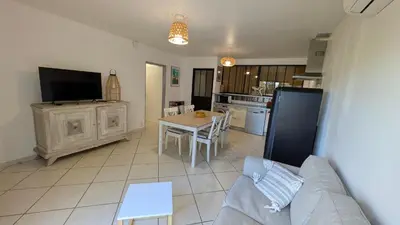 a living room with a couch and a table at gite de l'ille, avec terrasse et parking privé in Peyriac-de-Mer