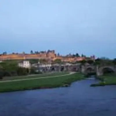 a view of a river with a city in the background at Aude Cité-City in Carcassonne