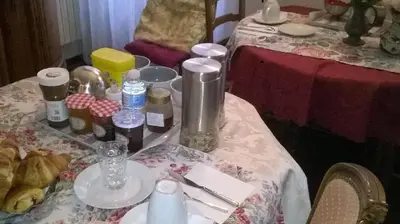 a table with a table cloth with bottles on it at Aude Cité-City in Carcassonne