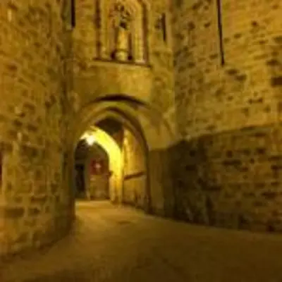 an alley in an old stone building with an archway at Aude Cité-City in Carcassonne