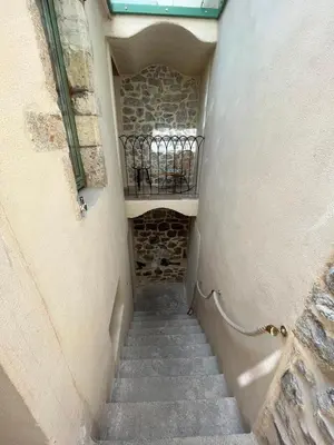 a stairway leading up to a building with a balcony at Maison Gruissan village in Gruissan
