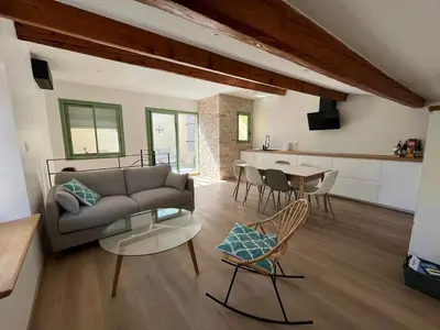 a living room with a couch and a table at Maison Gruissan village in Gruissan