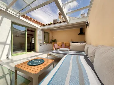 a living room with a couch and a table at Maison Gruissan village in Gruissan