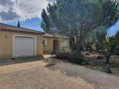 a house with a tree and a white garage at Villa de l Ode in Mirepeisset