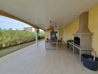 an outdoor patio with a fireplace in a house at Villa de l Ode in Mirepeisset