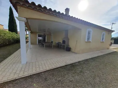 a house with a large patio in front of it at Villa de l Ode in Mirepeisset