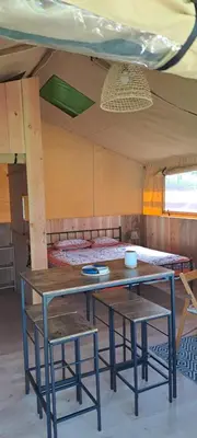 a table and two chairs in a room at grote lodge safaritent 4 in Camurac